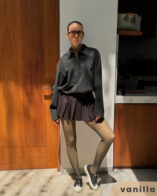 Woman in a trendy outfit wearing the vanilla Grace Fleece Lined tights.